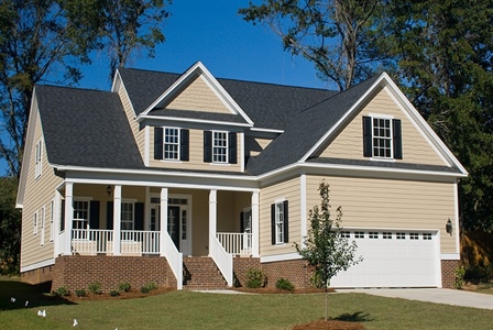 Home with beige siding and black roofing and shutters.